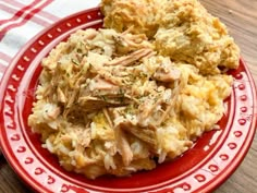 a red plate topped with mashed potatoes and meat