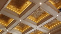 the ceiling is decorated with gold and white paint, which gives it a dramatic effect