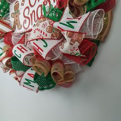 a christmas wreath made out of burlocks and ribbons