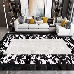 a living room filled with white couches and black and white rug on top of a hard wood floor