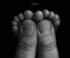 a person's feet and toes are shown in black and white