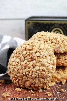 three cookies stacked on top of each other next to a black and white napkin with a box in the background