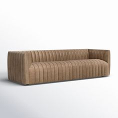 a brown couch sitting on top of a white floor