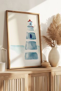 a watercolor painting of a lighthouse on a shelf