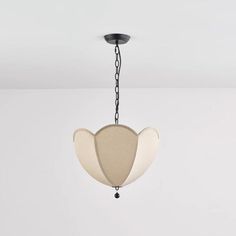 a white and black chandelier hanging from a ceiling