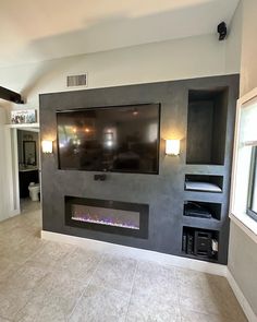 a large flat screen tv mounted to the side of a wall in a living room