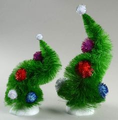 two green christmas trees with red, white and blue decorations on top of each other