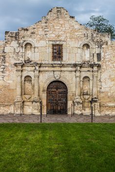 an old stone building with two doors on the front and one door in the back