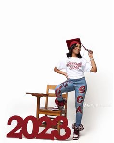 a woman sitting on top of a wooden chair next to a sign that reads 202