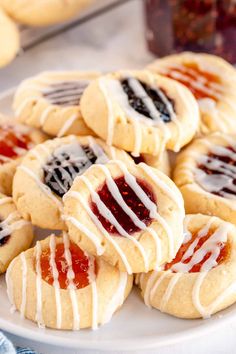 jam thumbprint cookies on a white plate with the title text overlay reads jam thumbprint cookies