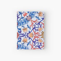 a blue and orange floral patterned notebook on a white background