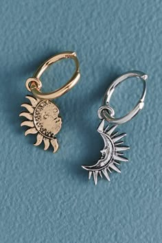 <p>Go for a mismatched look with a celestial vibe! These gold and silver-colored mini hoop earrings feature a sun and a coordinating moon. </p> Pair Bracelets, Sun And Moon Wedding, Sun And Moon Jewelry, Sun Moon Earrings, Sun Outfit, Sun And Moon Earrings, Moon Jewellery, Earrings Matching, Ear Pin