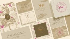 several different types of business cards on a white surface with pink and gold accents, including the logo for eden essenice