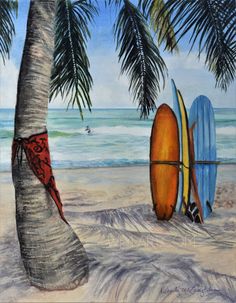 two surfboards leaning against a palm tree on the beach