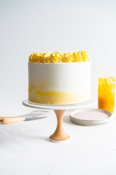 a white cake with yellow frosting on top