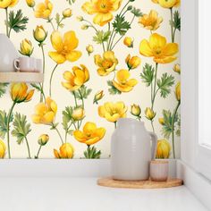 yellow flowers painted on a wall next to two vases and a shelf in front of it