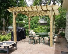 an outdoor patio with table, chairs and grill