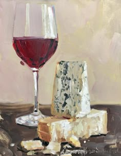 a piece of cheese and a glass of wine