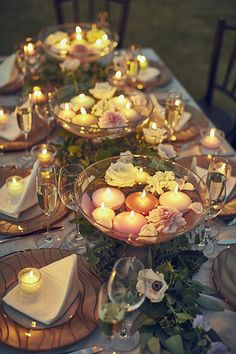 the table is set with candles and plates