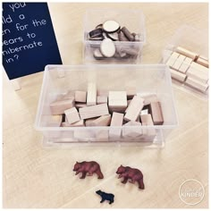 two plastic bins filled with wooden blocks and magnets