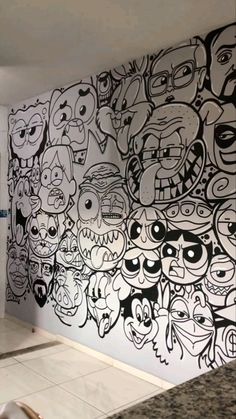 the wall is decorated with many cartoon faces