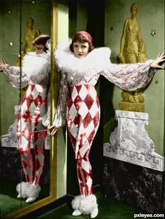 two women dressed in red and white checkered outfits are standing in front of a mirror