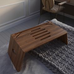 a wooden coffee table sitting on top of a rug next to a chair and desk