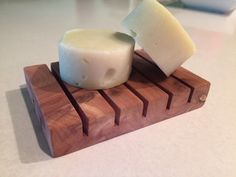 two pieces of cheese sitting on top of a cutting board