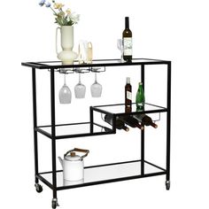 a black metal bar cart with wine glasses and bottles on it's shelf,