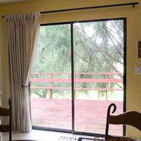 a living room filled with furniture and a sliding glass door