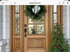 the front door is decorated with wreaths and greenery