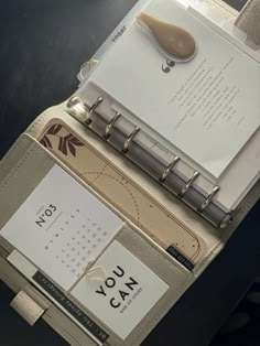 an open planner book sitting on top of a table