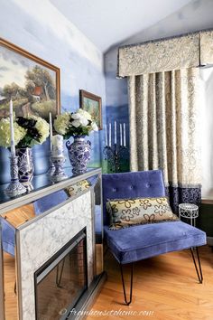 a living room filled with furniture and flowers on top of a fireplace mantel in front of a painting