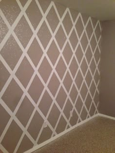 an empty room with some white lines painted on the wall and carpeted flooring