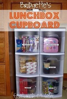 the lunchbox cupboard is organized with plastic containers