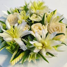 a bouquet of white and yellow flowers on a plate