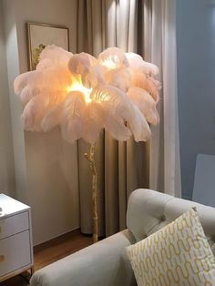 a lamp that is on top of a table next to a couch in a living room