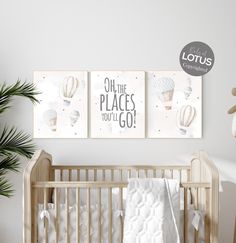 a baby crib with two pictures hanging on the wall