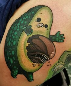 a tattoo on the side of a woman's stomach with an avocado