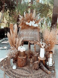 there is a wooden sign with flowers and plants on it in front of some trees