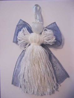 a white and blue christmas ornament hanging on a wall