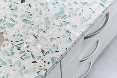 the counter top is covered with broken glass shards, and there's a sink in front of it