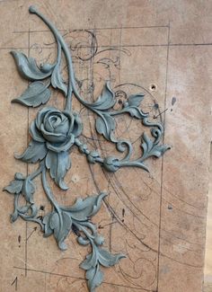 an intricately carved rose on the side of a wall