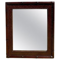 a wooden frame mirror sitting on top of a white wall