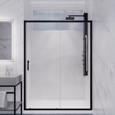 a white bathroom with black trim and glass shower door