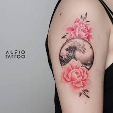 a woman's arm with pink flowers on it