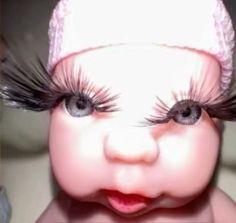 a close up of a baby with fake eyelashes