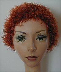 a mannequin head with red hair and green eyes