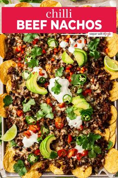 a tray filled with nachos topped with meat, cheese and avocado