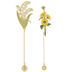 two brooch pins with flowers and leaves on them